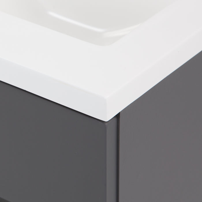 Corner of Brennan gray 18 inch hardware-free compact bathroom vanity with 1 door and white sink top