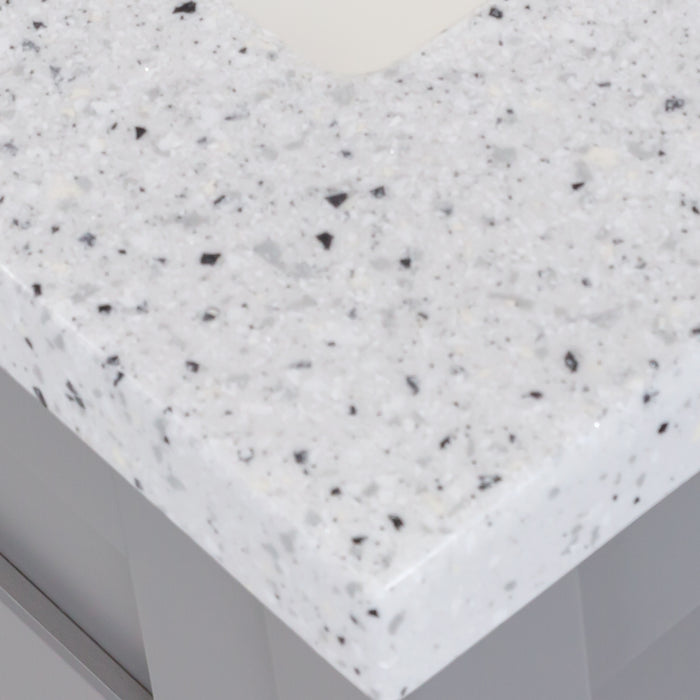 Close view of the corner of the 24.5” wide Marilla bathroom vanity cultured marble sink top with an integrated white sink and a 2.19" high backsplash  - shown here in silver ash sink top