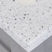 Close view of the corner of the 24.5” wide Marilla bathroom vanity cultured marble sink top with an integrated white sink and a 2.19" high backsplash  - shown here in silver ash sink top