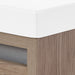 Corner detail on Trente 24 inch 2-door, 1-drawer, bathroom vanity with woodgrain finish and white sink top