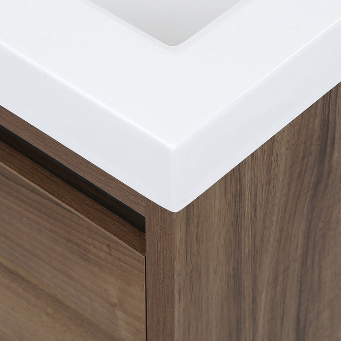 Corner detail on Trente 24 inch 2-door, 1-drawer, bathroom vanity with woodgrain finish and white sink top