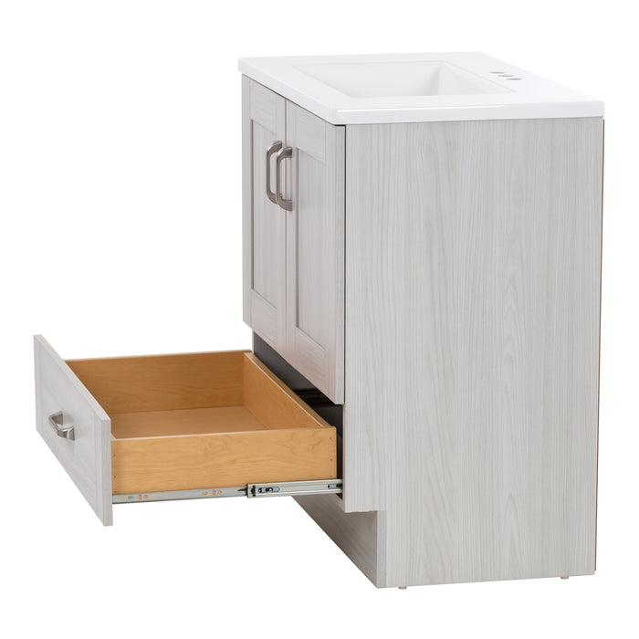 Side view of 30.25" Noelani powder room vanity features a transitional design with inset Shaker-style doors, flat-panel drawer – shown extended in this image, and satin nickel door and drawer pulls – shown here in Elm Sky finish