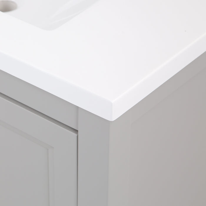 Corner closeup on Destan 30 in light gray bathroom vanity with base drawer, cabinet, polished chrome hardware, white sink top