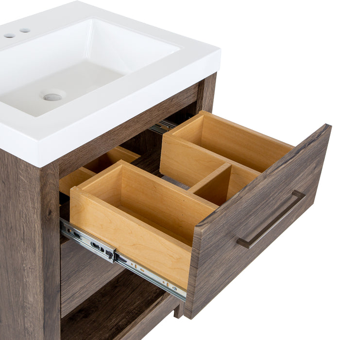 Closeup of top drawer with 3 compartments of white cultured marble sink top on Fisk  24.5" W woodgrain cabinet-style bathroom vanity