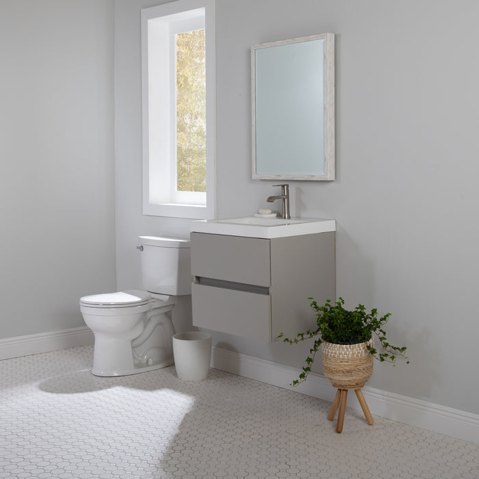 Innes 24.5" W gray floating bathroom vanity installed in bathroom with faucet