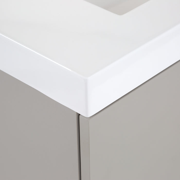 Closeup of corner Innes 30.5" W gray floating bathroom vanity with 2 flat-panel drawers, white sink top