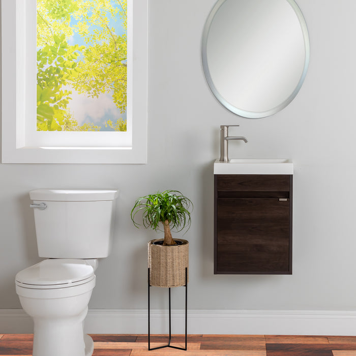Kambree 15.75 in. floating 1-door bathroom vanity with dark woodgrain finish and white sink top installed in bathroom with mirror, faucet, toilet