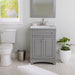 Maris 24.5" 2-door gray Powder Room Vanity, stone-look sink top installed in bathroom with faucet, toilet, plant, mirror