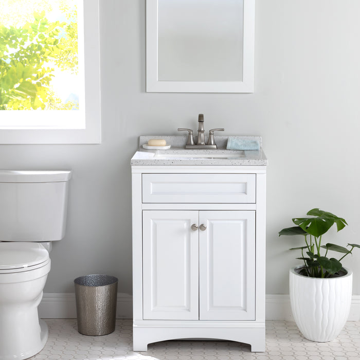 Maris 24.5" 2-door White Powder Room Vanity, stone-look sink top installed in bathroom with faucet, toilet, plant, mirror