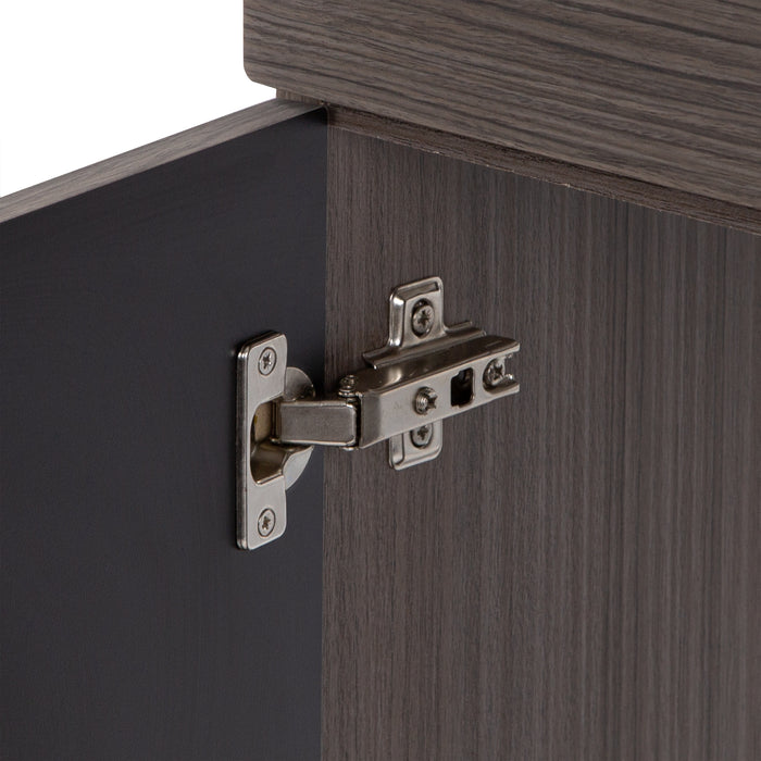 Close up of 6-way adjustable hinges on medium woodgrain, Merton vanity by Spring Mill Cabinets