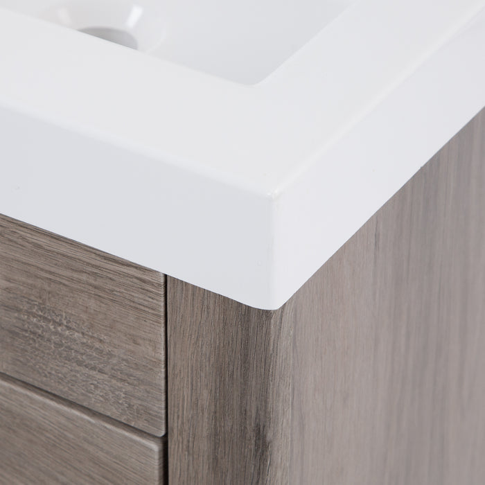 Closeup of corner of white cultured marble sink top on Nixie woodgrain finish bathroom vanity