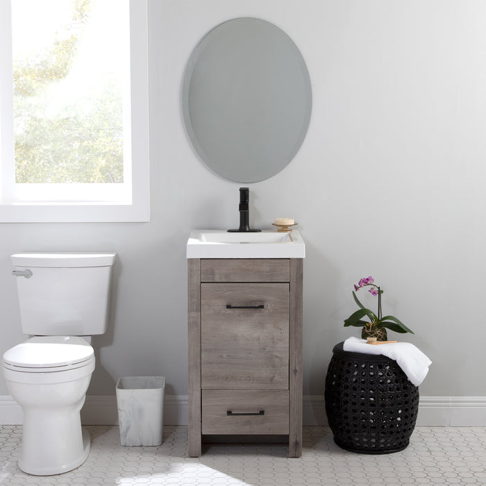 Nixie 18.5" wide woodgrain 1-door, 1-drawer bathroom vanity installed in bathroom with plant and toilet
