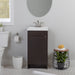 Merton 17" W vanity, dark woodgrain cabinet-style vanity with flat-panel door, satin nickel pull installed in bathroom with faucet