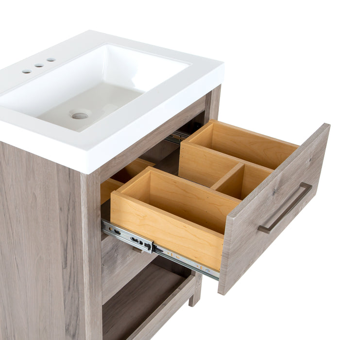 Closeup of top drawer with 3 compartments of white cultured marble sink top on Fisk  24.5" W woodgrain cabinet-style bathroom vanity 