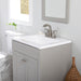 Wyre 24.5" W gray Shaker-style vanity with 2 flat-panel doors, white sink top installed in bathroom with toilet and mirror