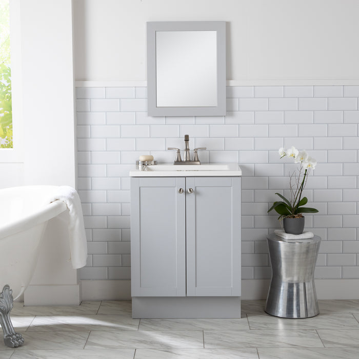 Yereli 24.25" W gray Shaker-style vanity with 2 flat-panel doors, white sink top installed in bathroom with tub and plant
