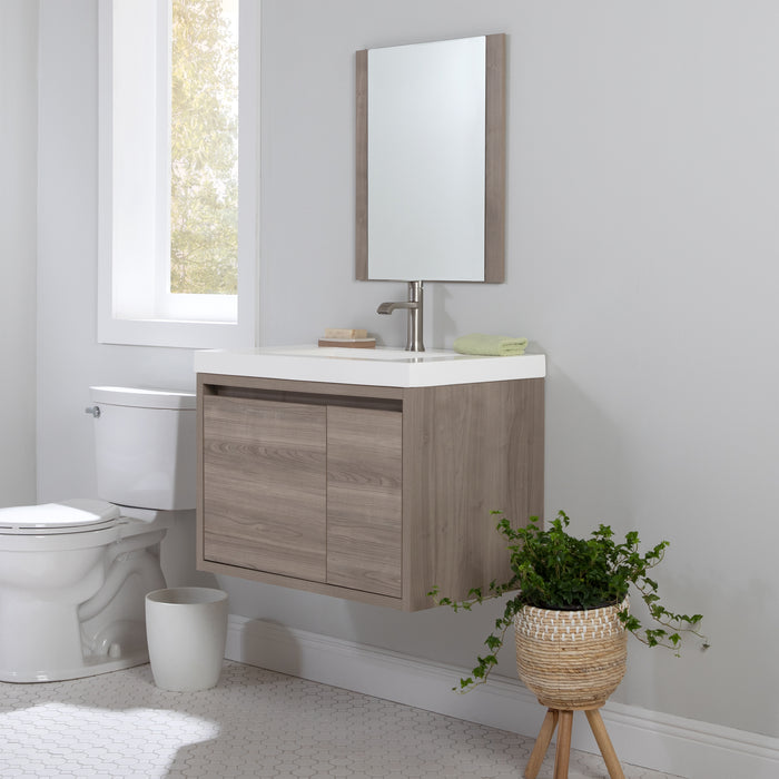  Kelby 30.5" W woodgrain cabinet-style floating bathroom vanity installed in bathroom between toilet and plant