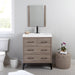 Rialta 30.5" W 3-drawer bathroom vanity with matte black legs installed in bathroom with faucet